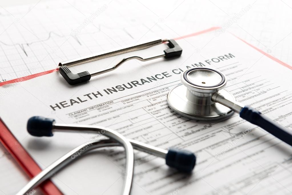 A stethoscope and some papers on top of a table.